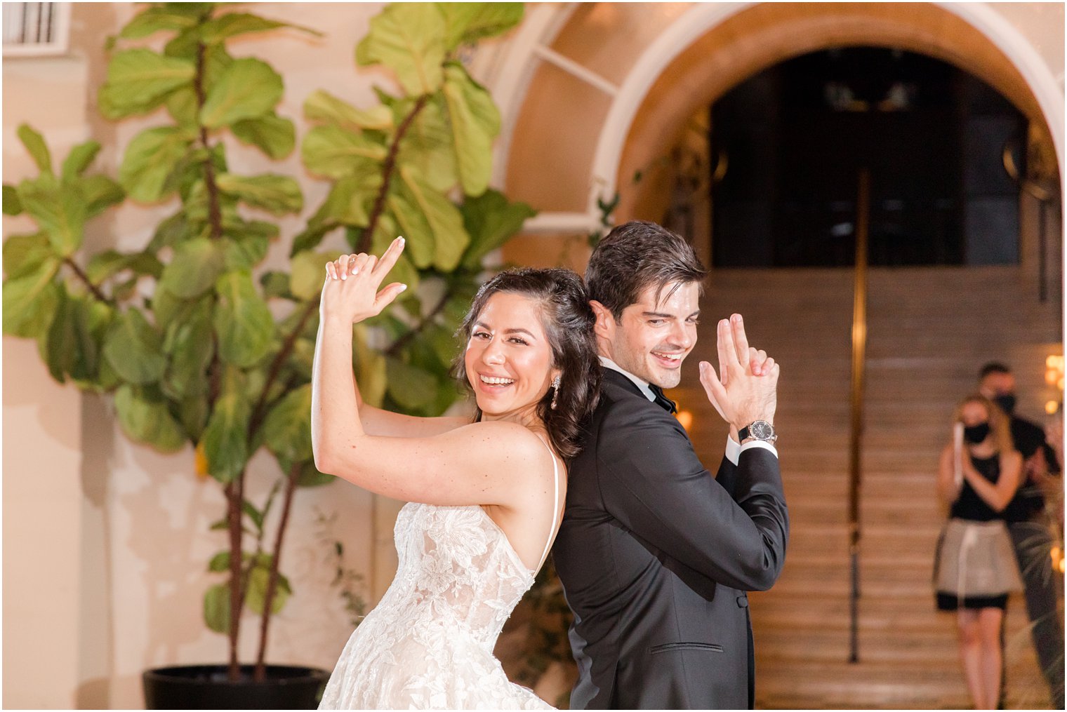 bride and groom strike "Charlie's Angel" pose