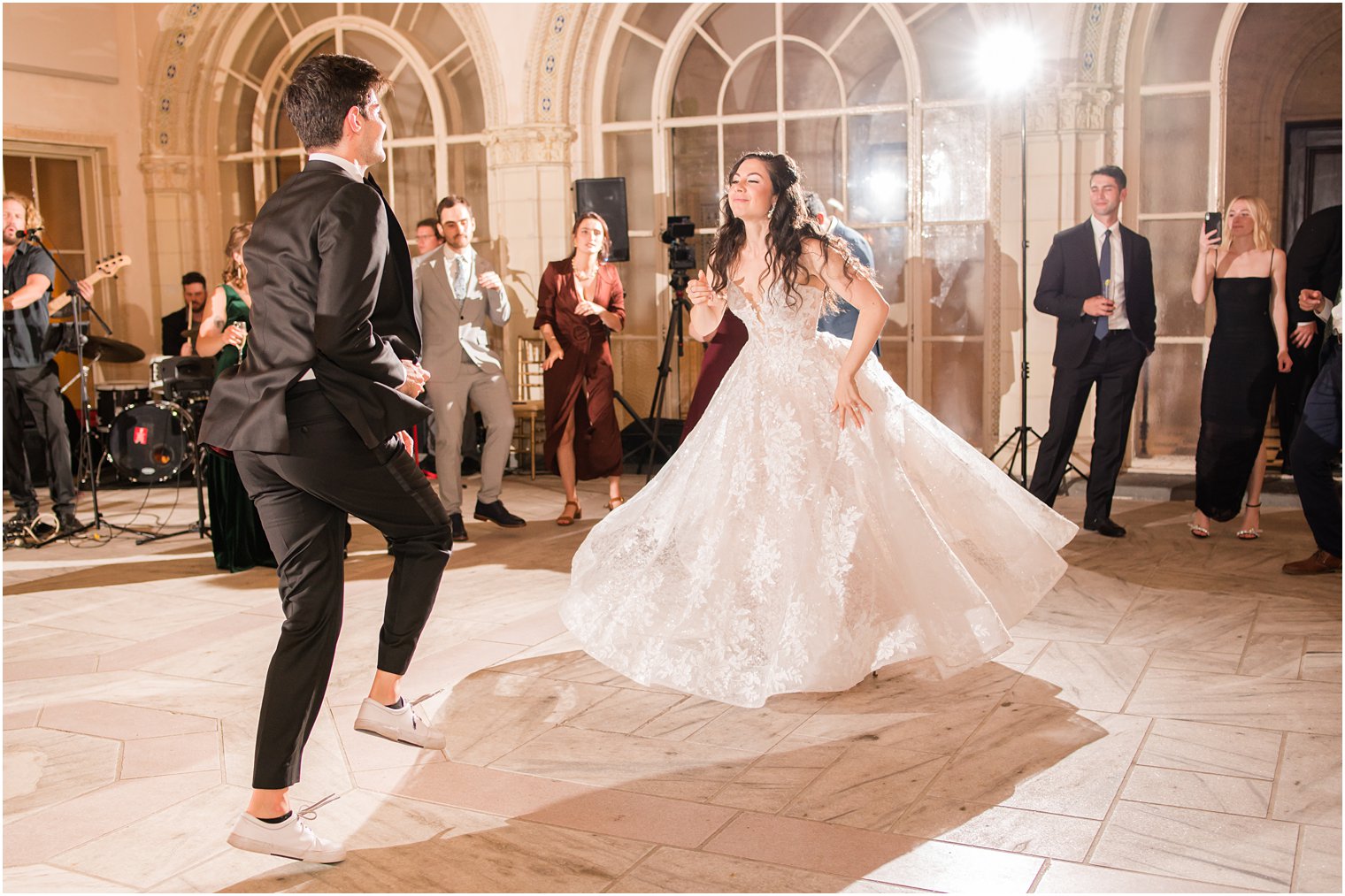 bride and groom dance to live music at Sands Point NY wedding reception