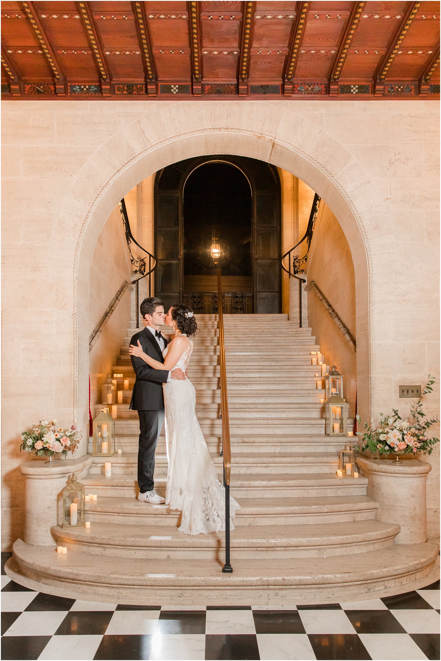 newlyweds kiss on staircase during Sands Point NY wedding reception