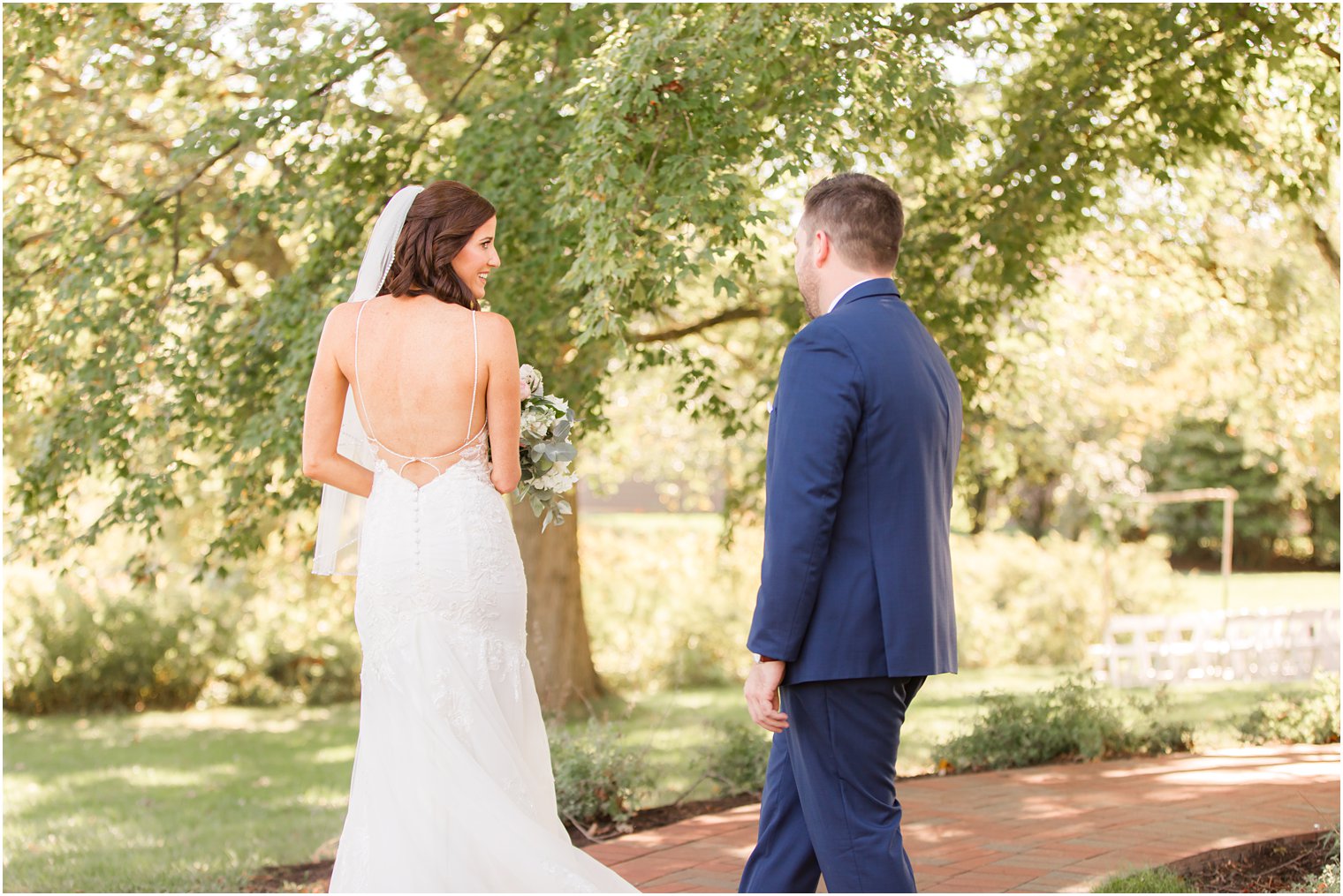 bride shows groom the back of her wedding gown during Chauncey Hotel wedding day