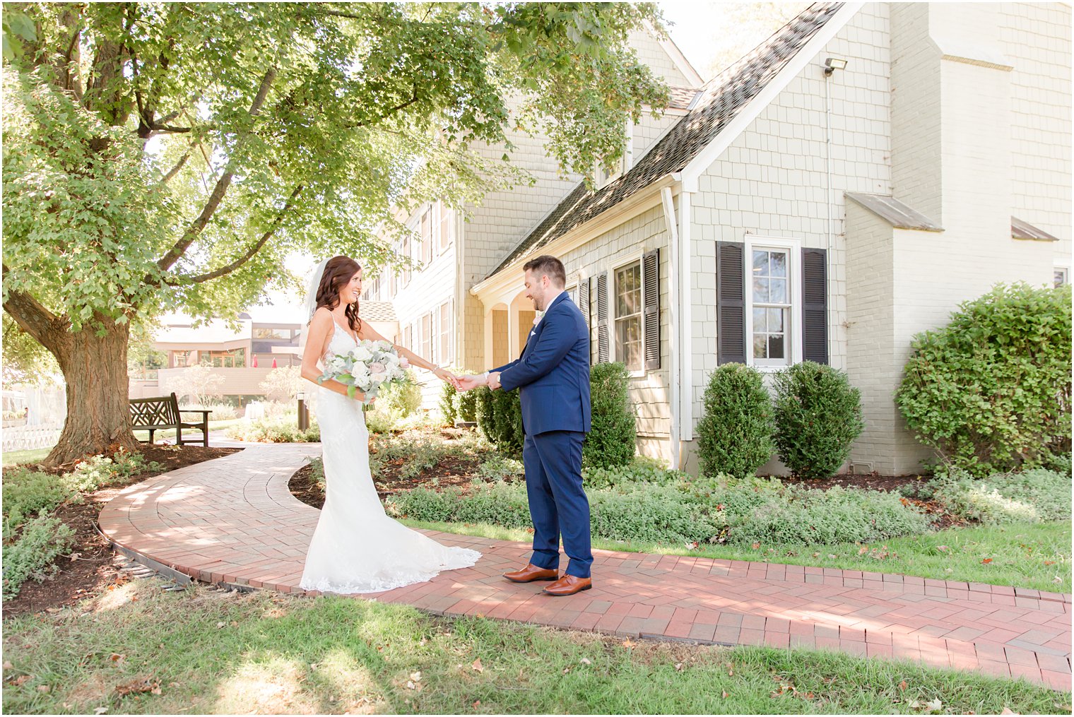 bride holds out hand to groom during first look at the Chauncey Hotel