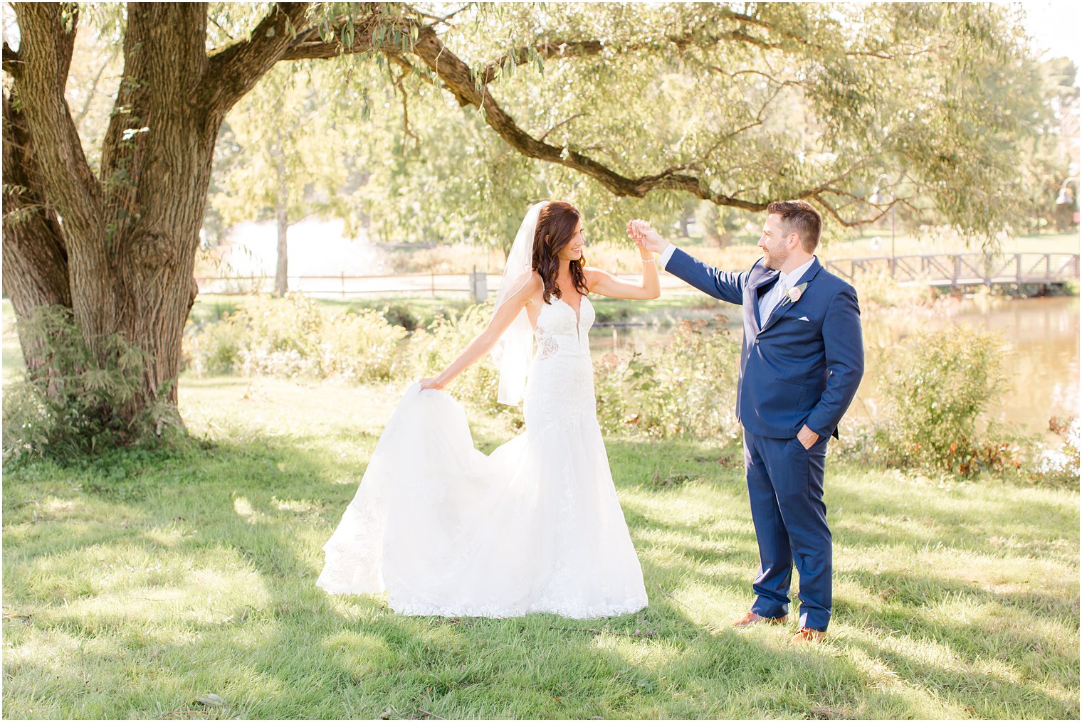 groom twirls bride during Princeton NJ wedding portraits 