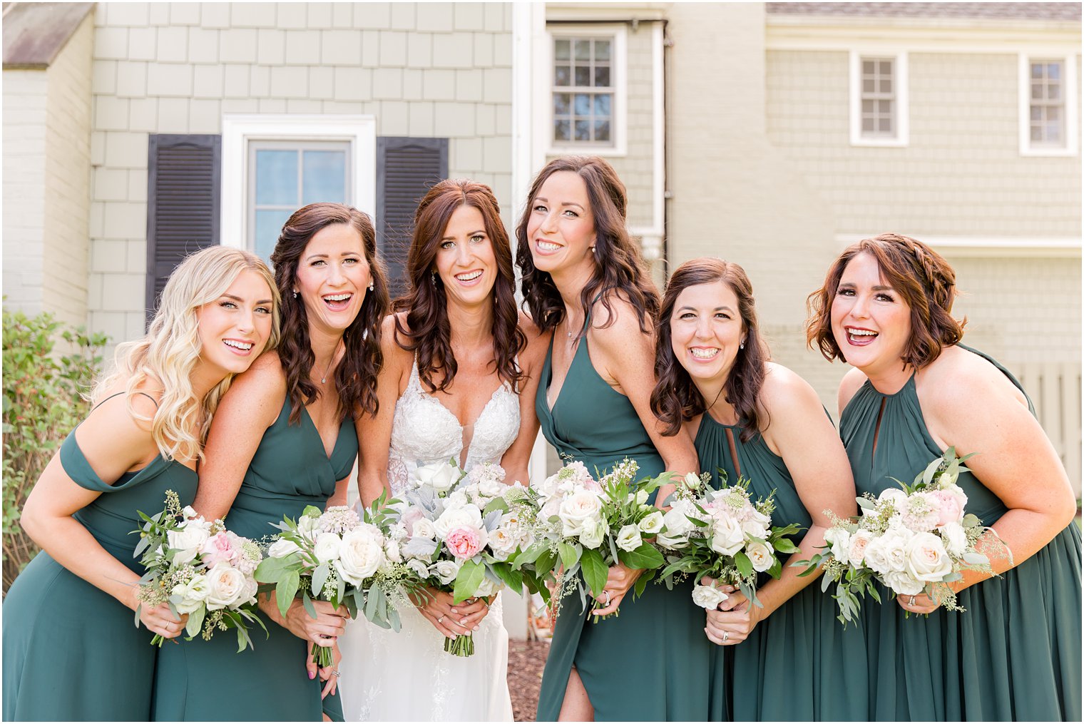 bride poses with bridesmaids in emerald green gowns for NJ Wedding 