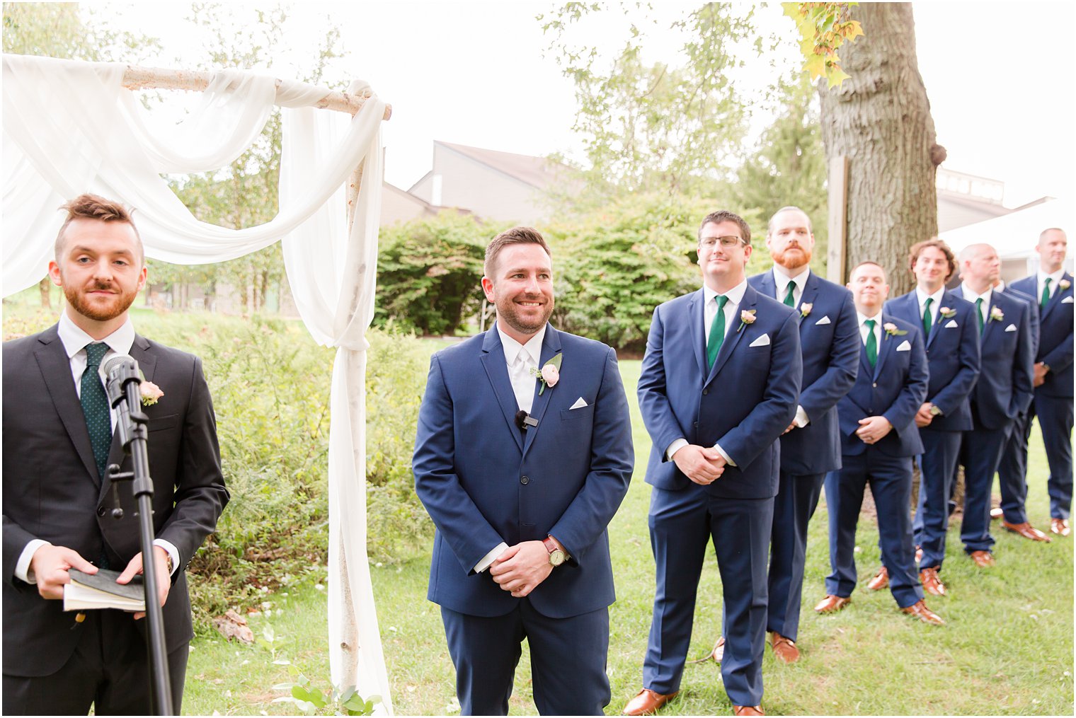 groom smiles watching bride walk down aisle at the Chauncey Hotel