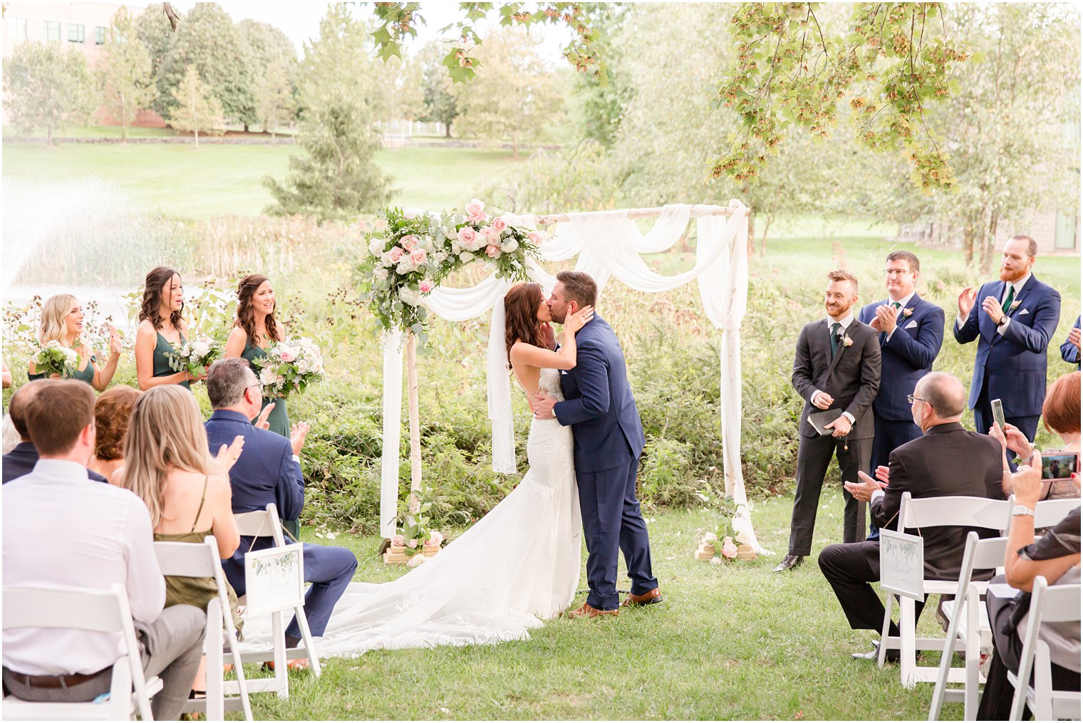 newlyweds kiss during outdoor wedding ceremony at the Chauncey Hotel