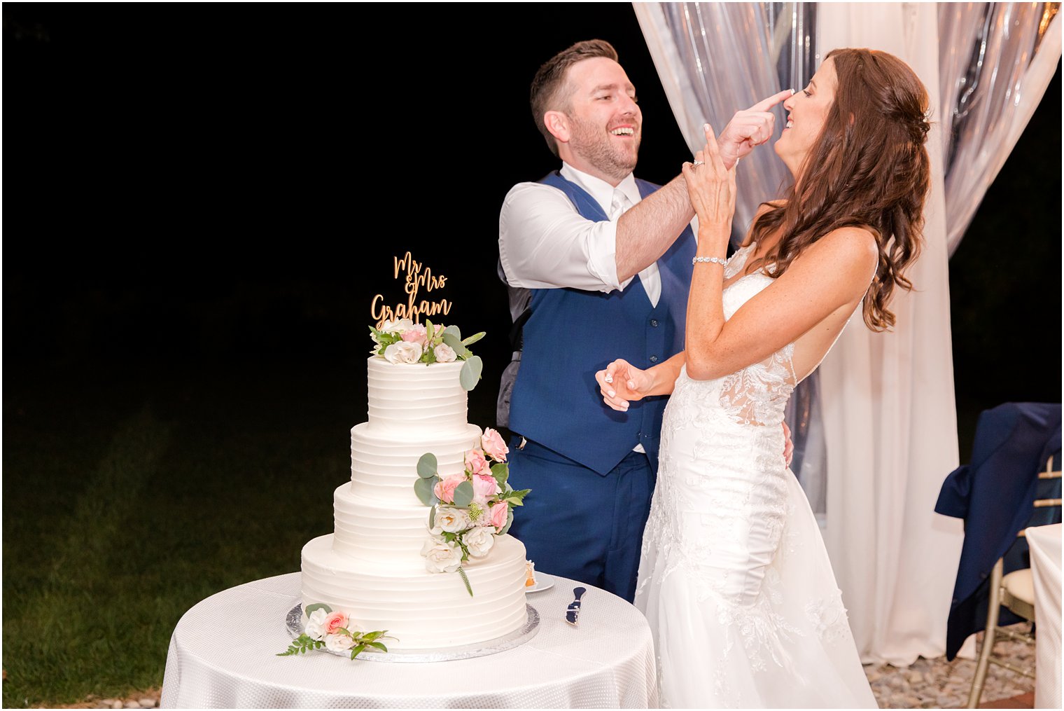 groom puts icing on bride's nose during Princeton NJ wedding reception