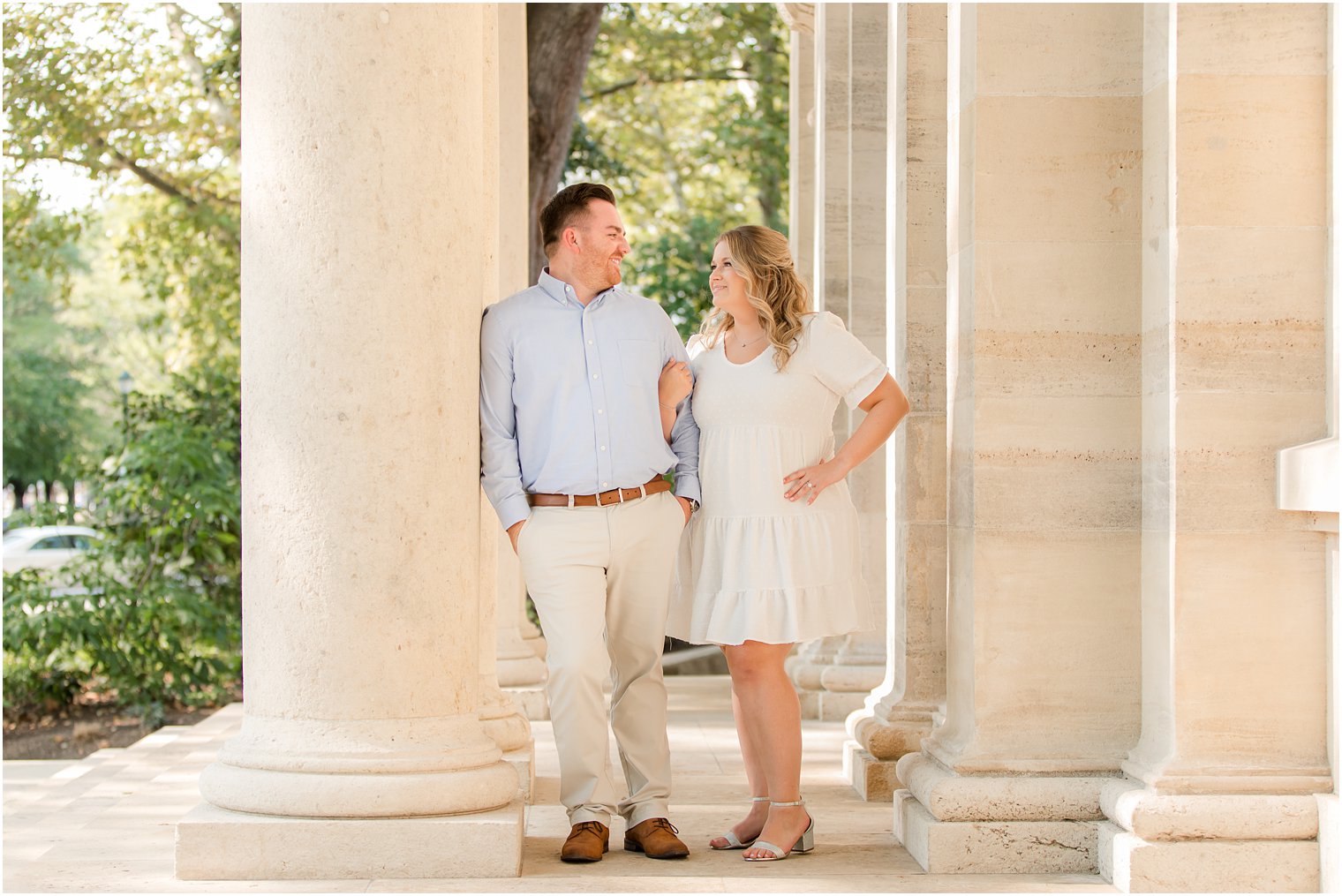 engaged couple leans against column at Rodin Museum 