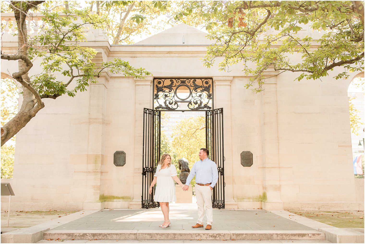 engaged couple stands by wrought iron gate during Rodin Museum engagement session