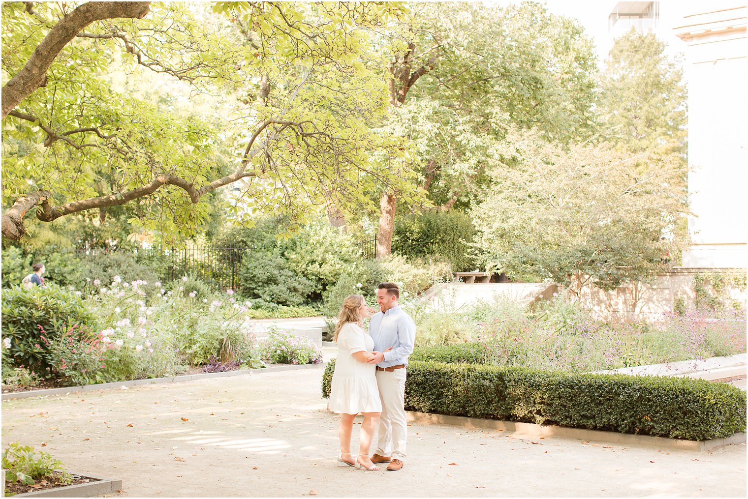 couple stands under trees during Rodin Museum engagement session