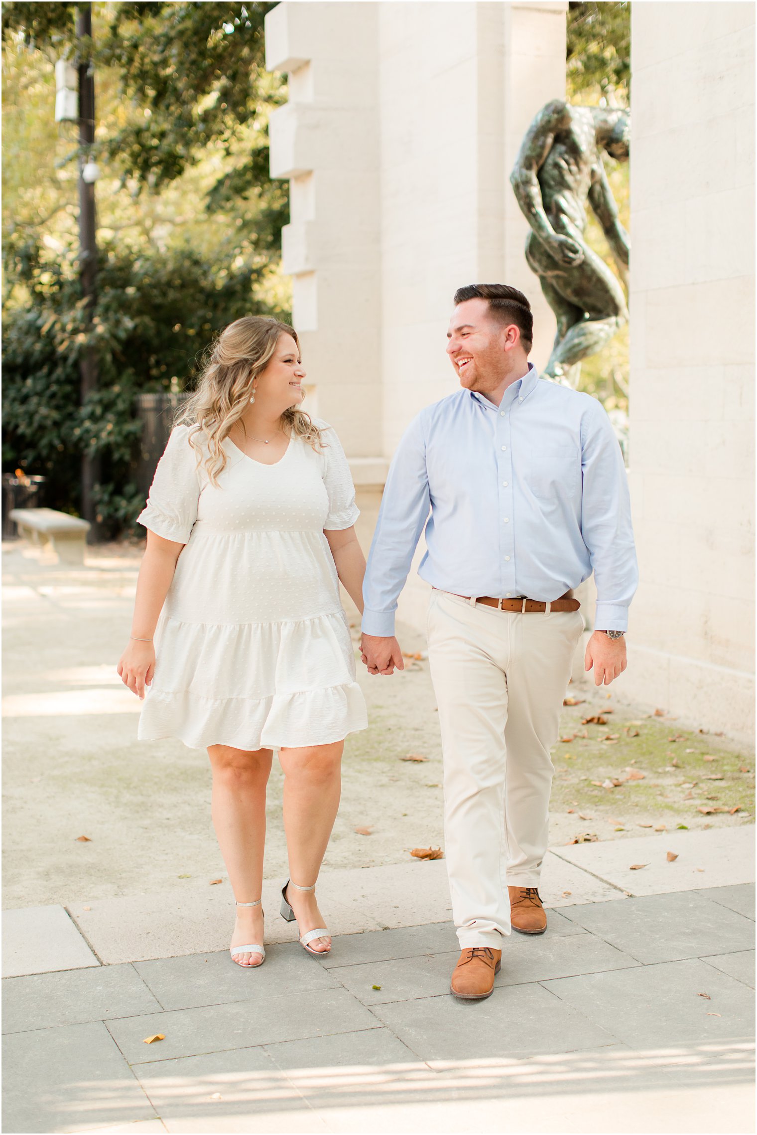 bride and groom hold hands walking up steps during Philly PA engagement photos