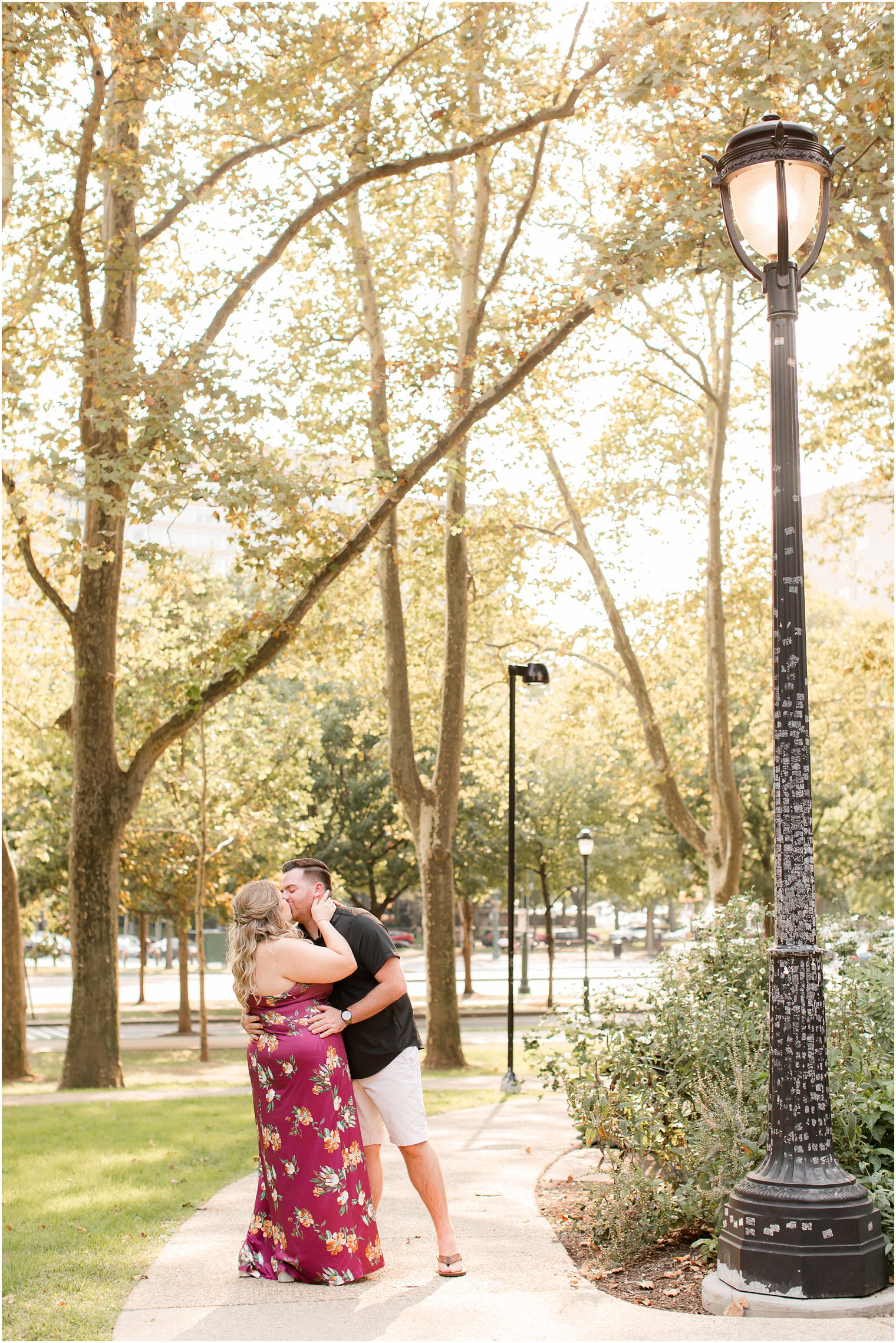 bride and groom kiss on sidewalk during Rodin Museum engagement session