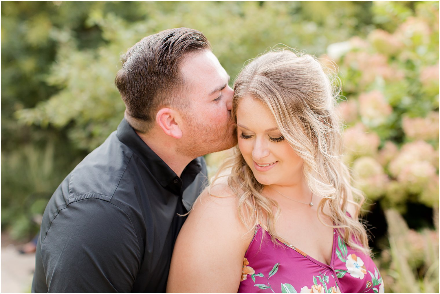 groom kisses bride's forehead during PA engagement session