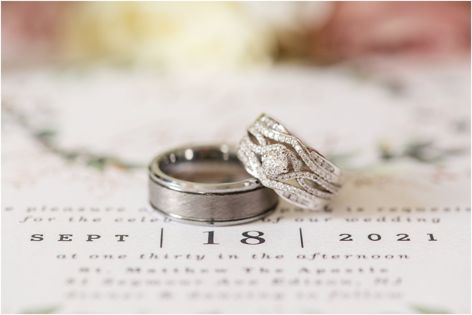 wedding rings rest on invitation for NJ wedding