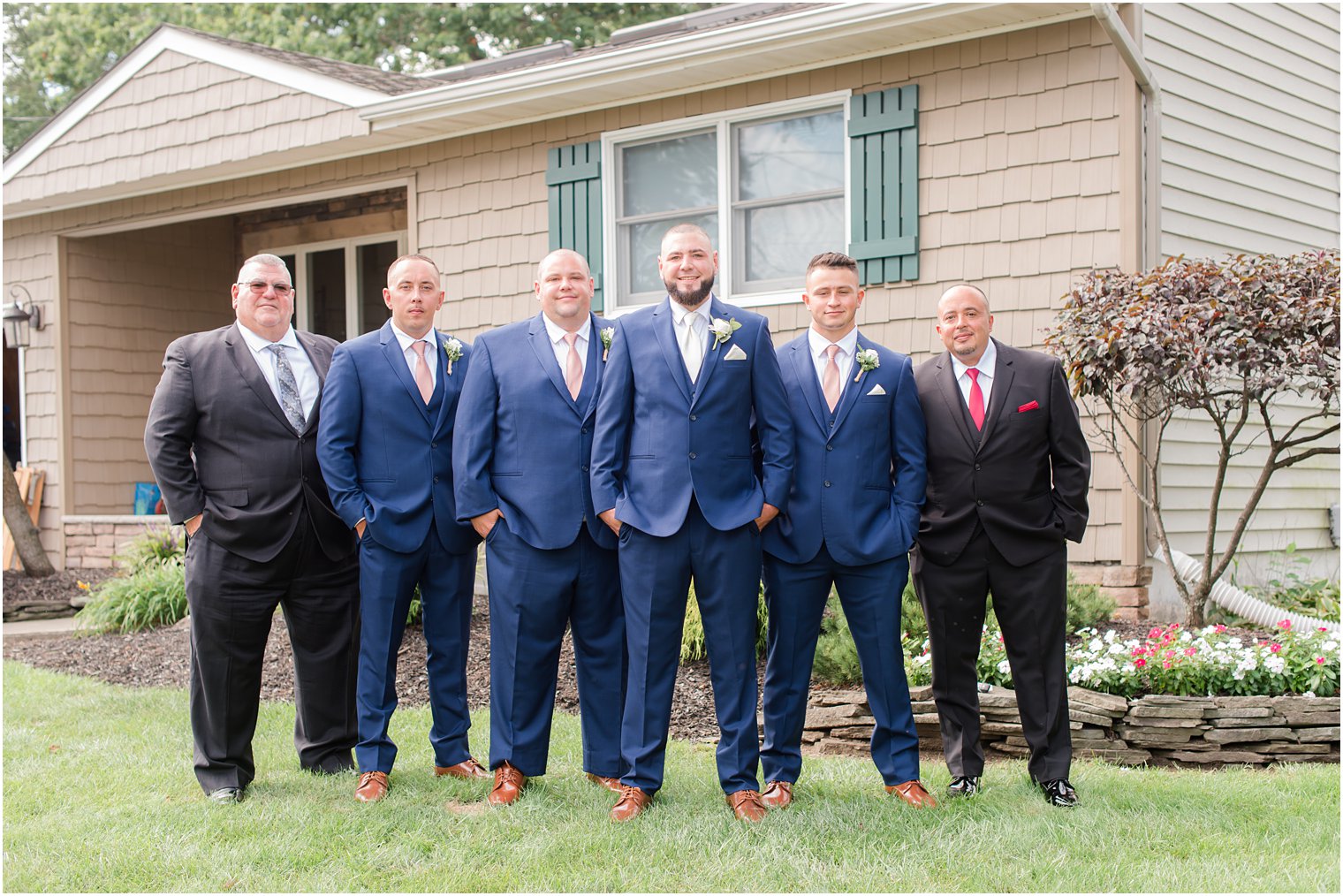 groom stands with groomsmen and dads before NJ wedding