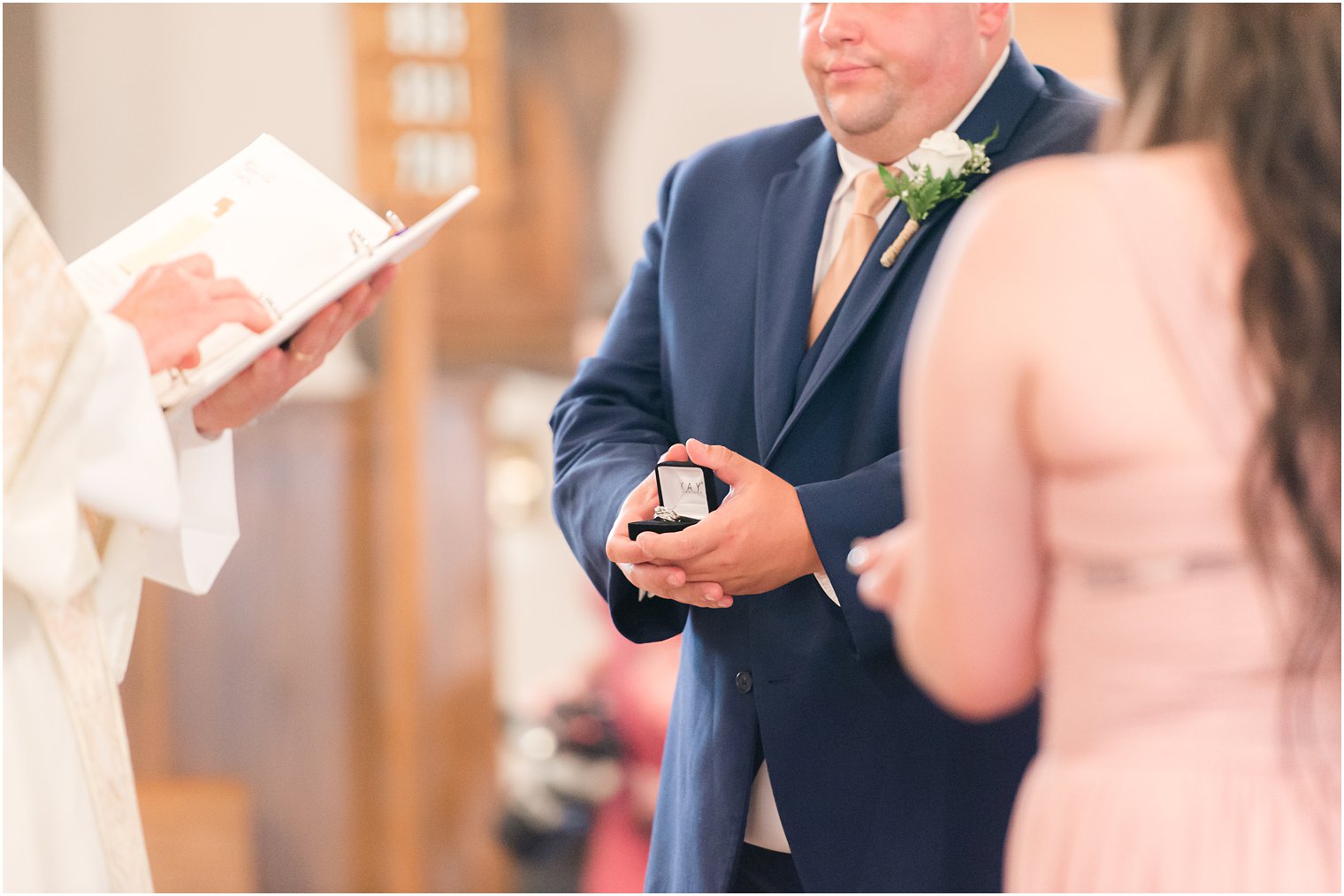 groomsman holds ring during ceremony in New Jersey 