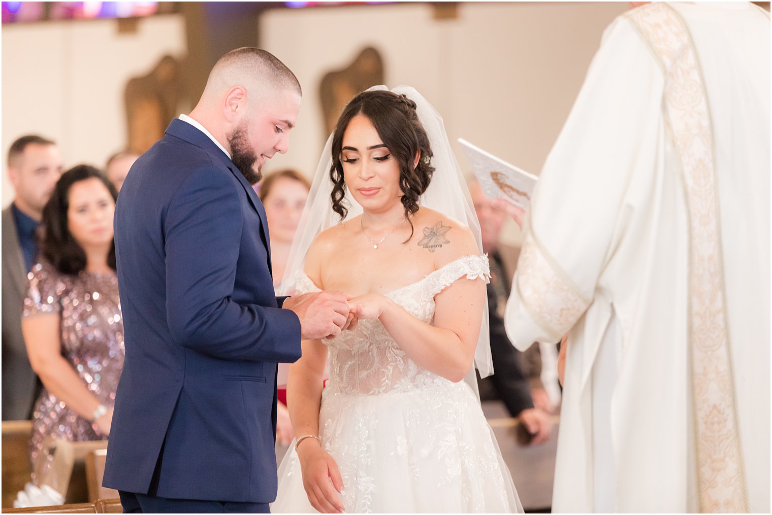 newlyweds exchange rings during traditional wedding ceremony at Saint Matthew the Apostle church
