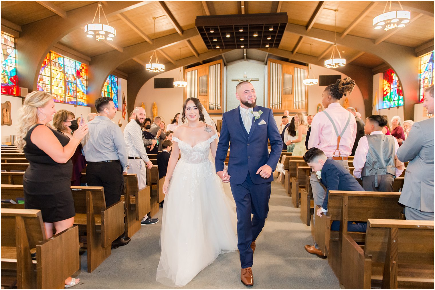 newlyweds leave traditional wedding ceremony at Saint Matthew the Apostle church