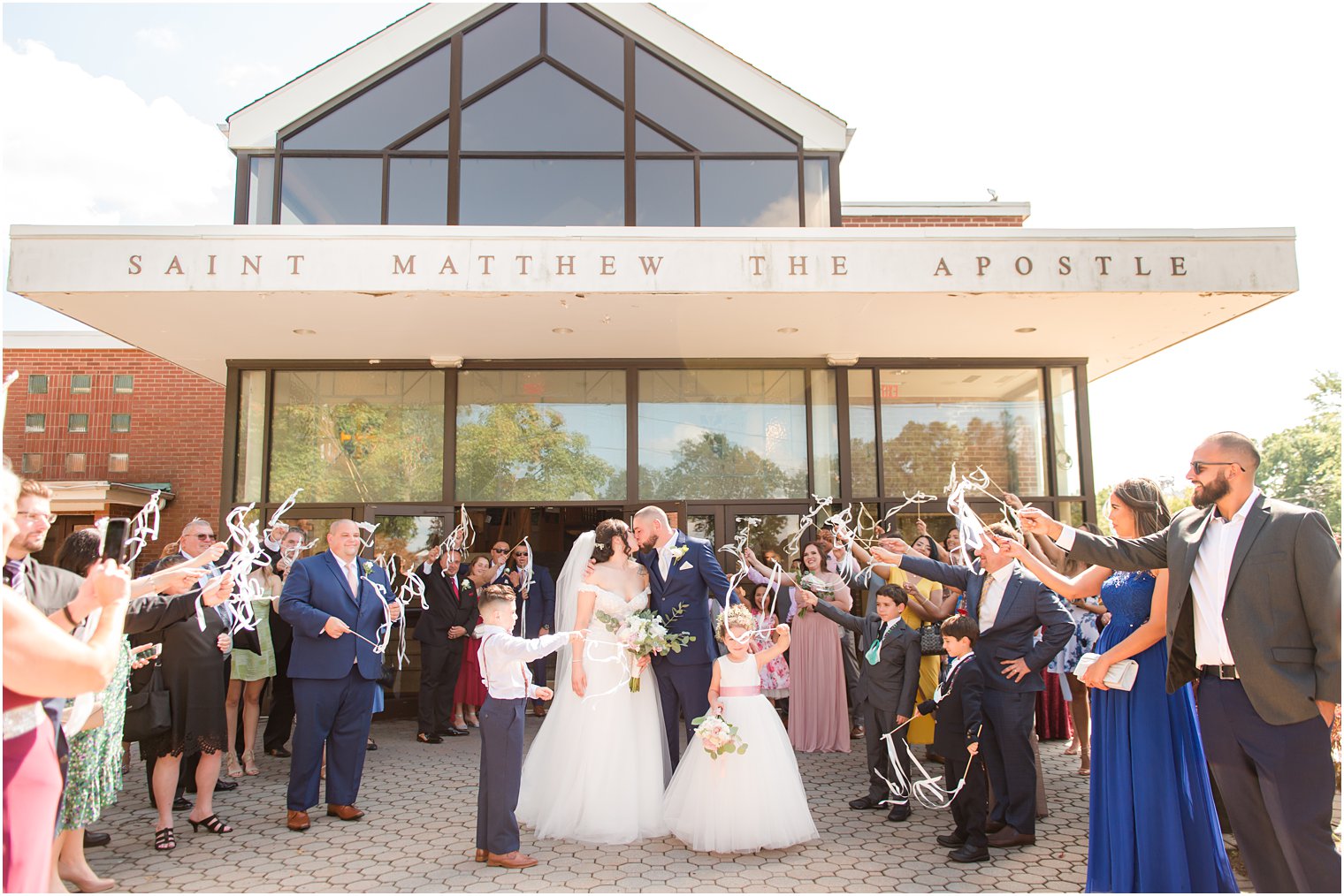 bride and groom kiss outside Saint Matthew the Apostle church in New Jersey