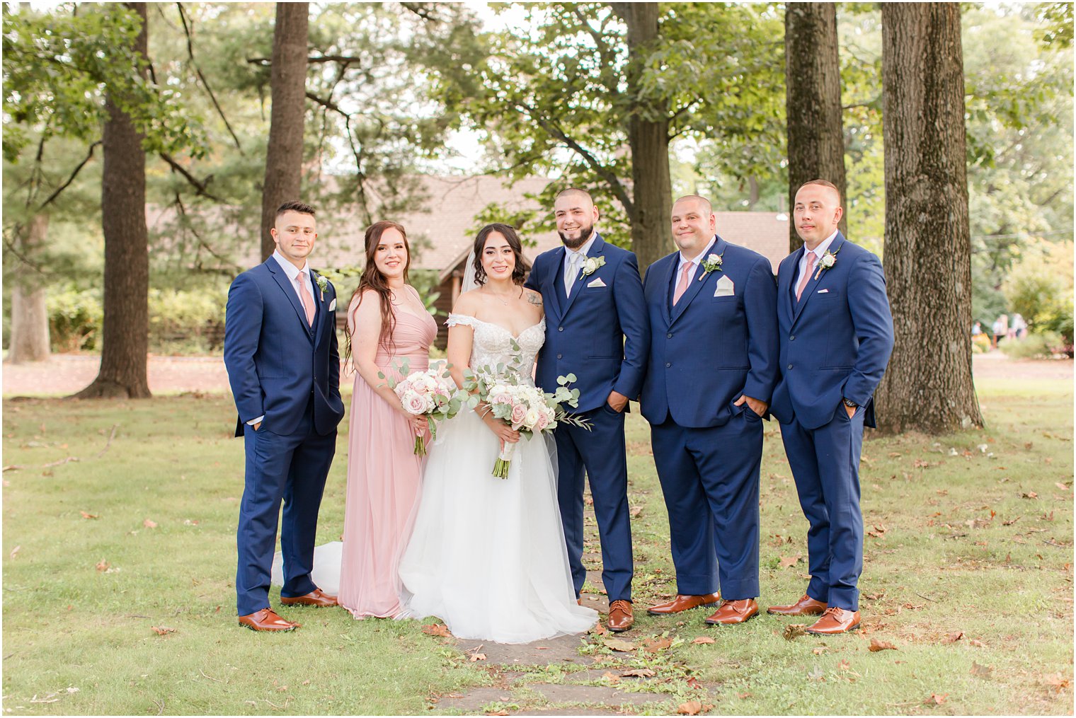 newlyweds pose with wedding party at Rutgers Gardens