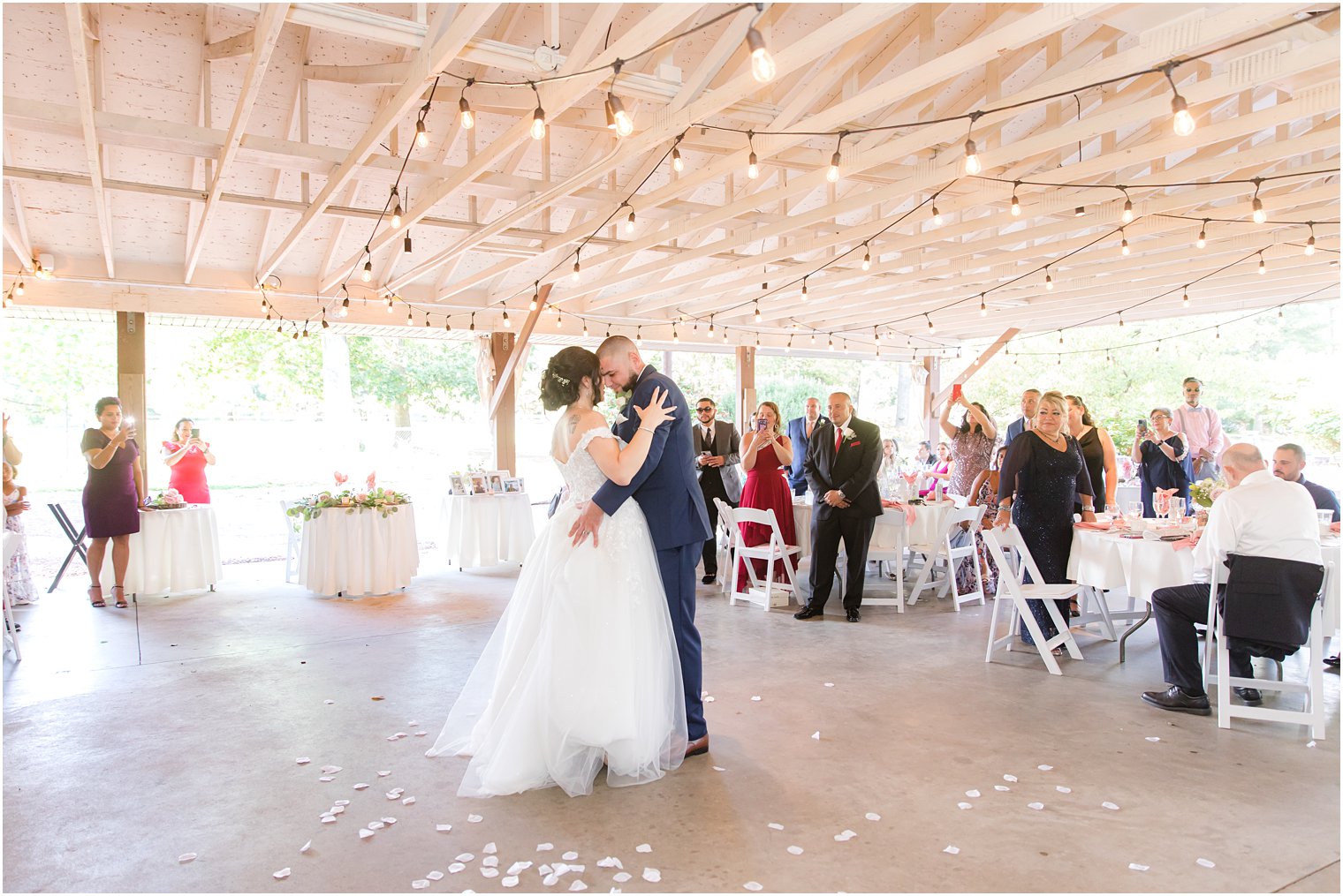newlyweds dance together in pavilion at Rutgers Gardens