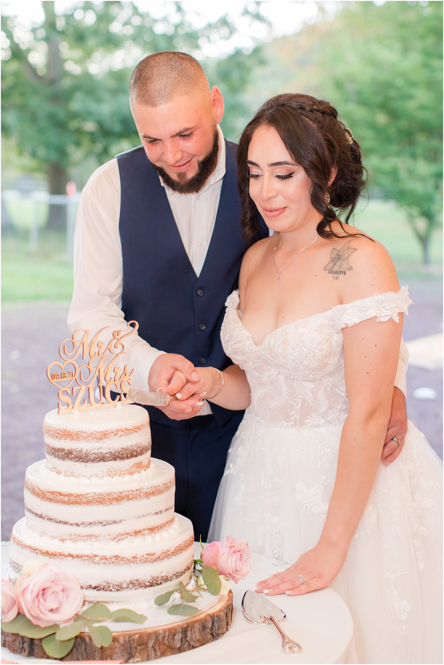 newlyweds cut naked wedding cake during NJ wedding reception 