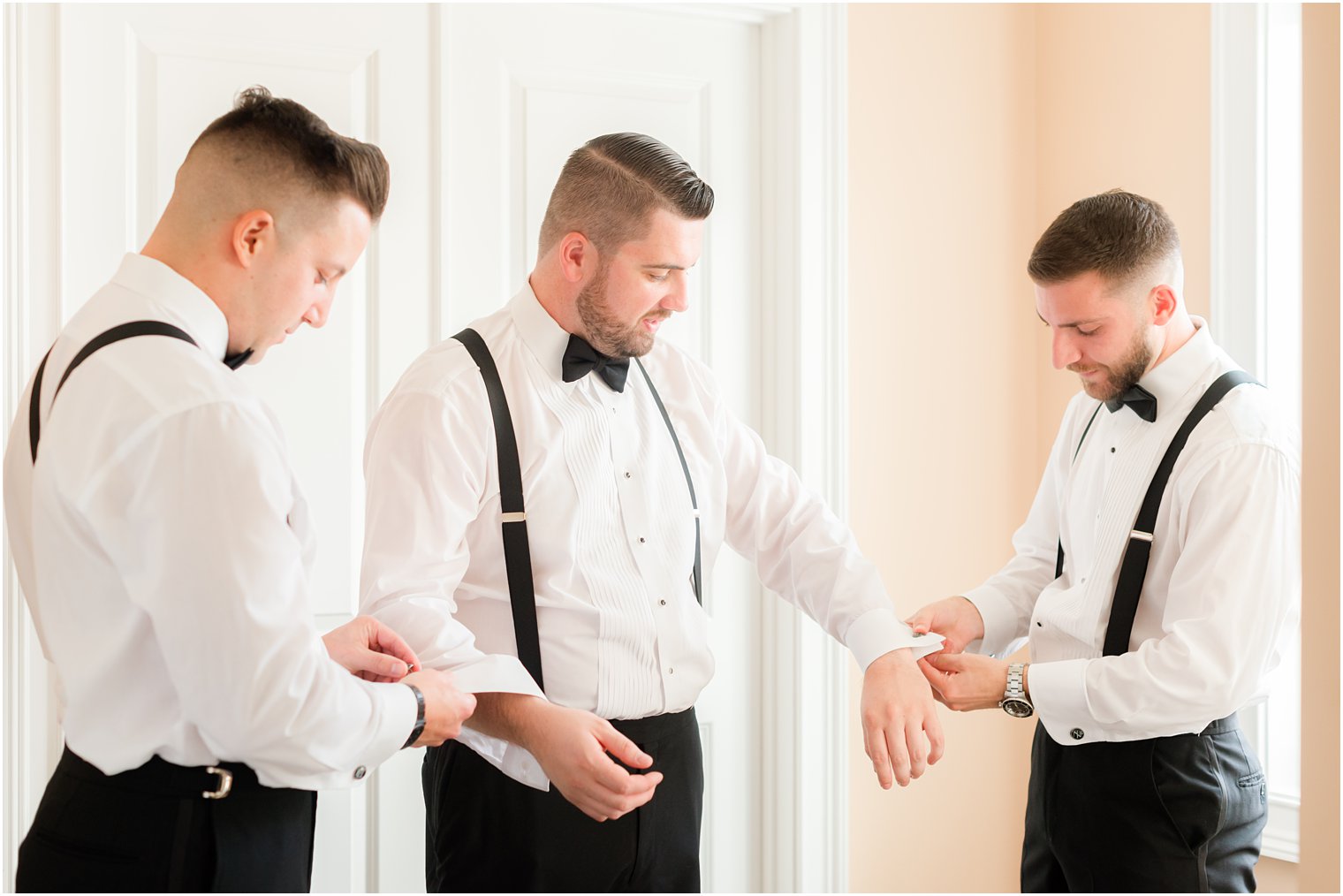 brothers help groom with cufflinks before NJ wedding