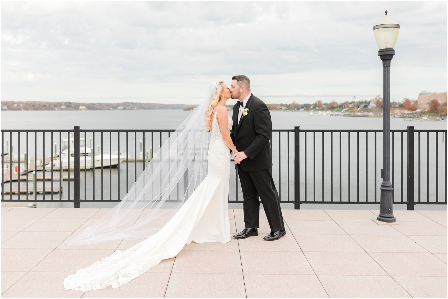 newlyweds kiss during first look overlooking the Red Bank marina 