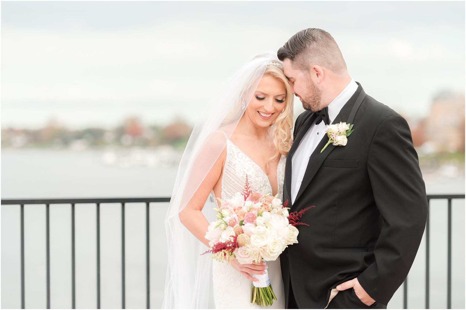 groom nuzzles bride's forehead during wedding portraits at the Molly Pitcher Inn