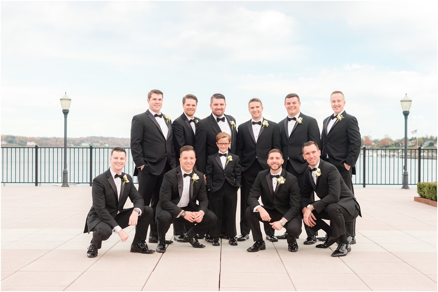 groom and groomsmen pose on patio at the Molly Pitcher Inn