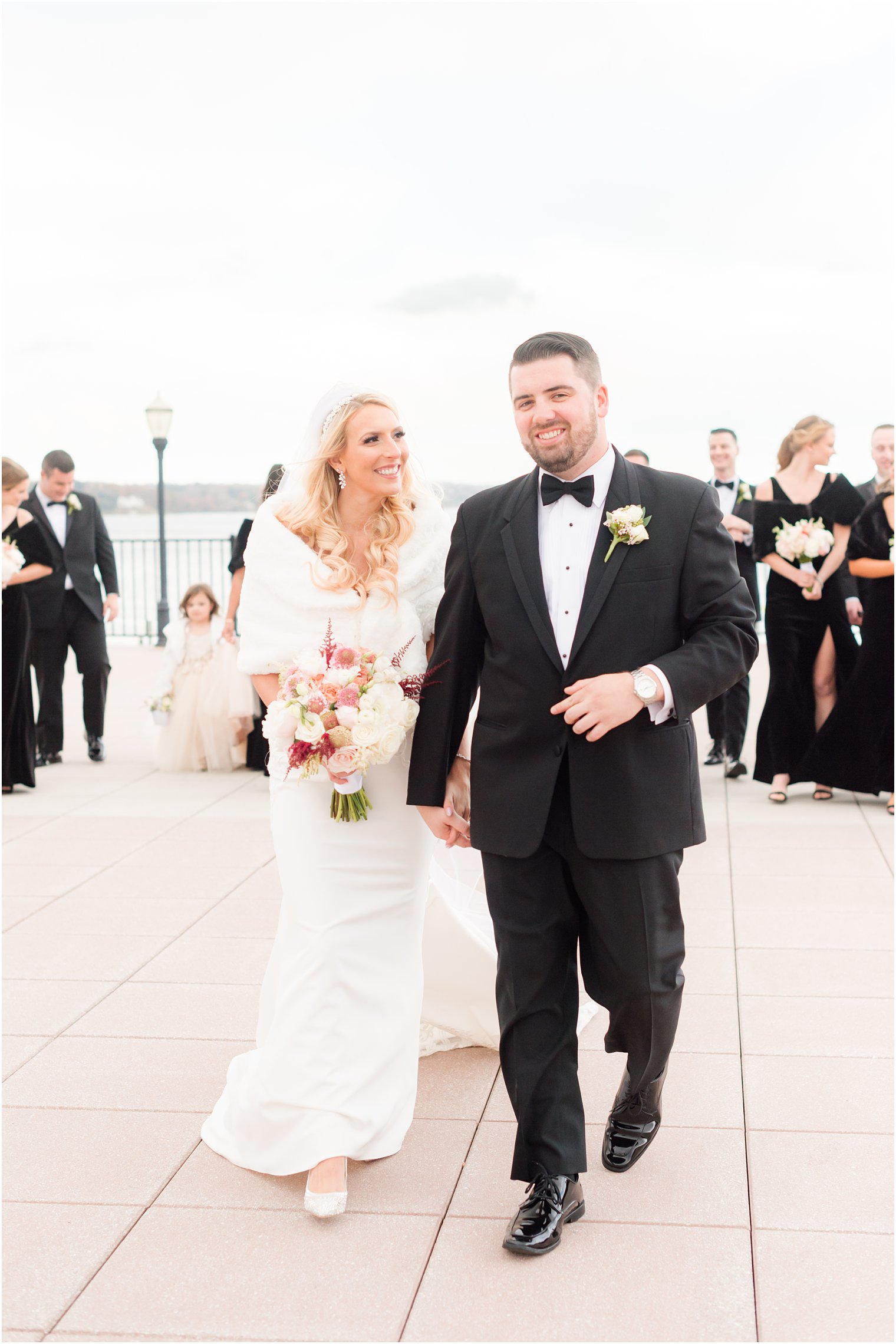 bride and groom walk with wedding party in Red Bank NJ