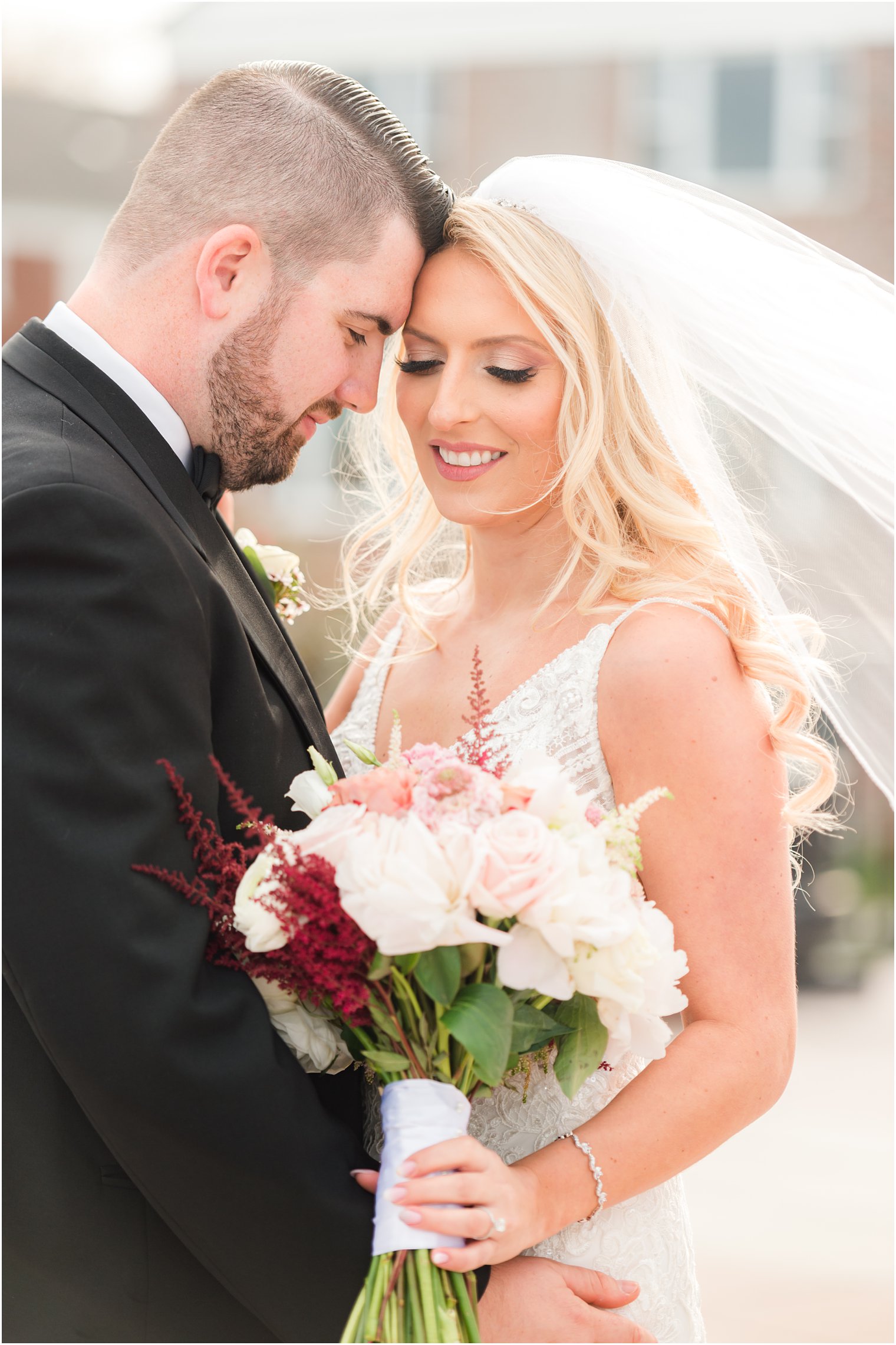 groom touches foreheads with bride during classic wedding portraits at the Molly Pitcher Inn