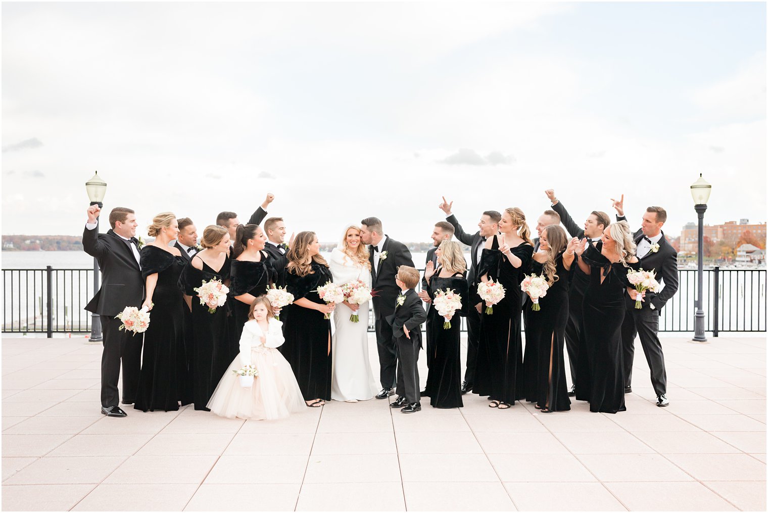 wedding party cheers with bride and groom outside the Molly Pitcher Inn