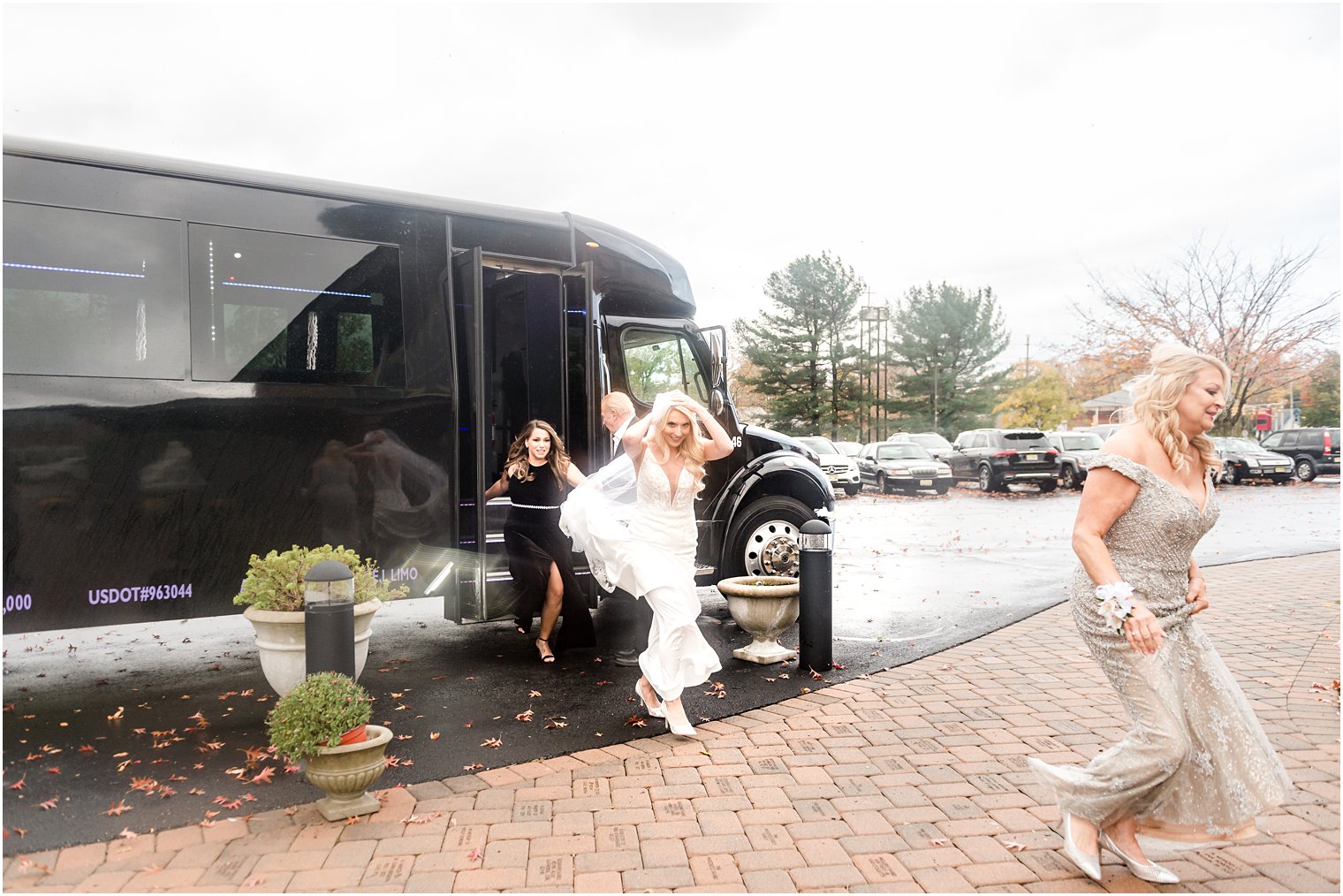 bridesmaid helps bride run into church during fall storm