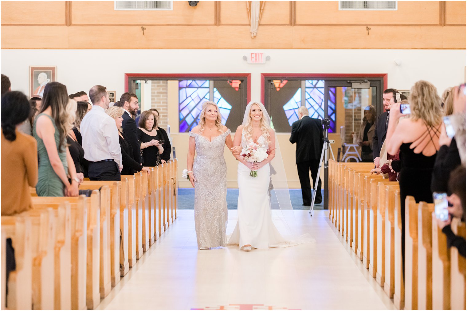 bride and mom walk down aisle before church wedding ceremony in Red Bank NJ