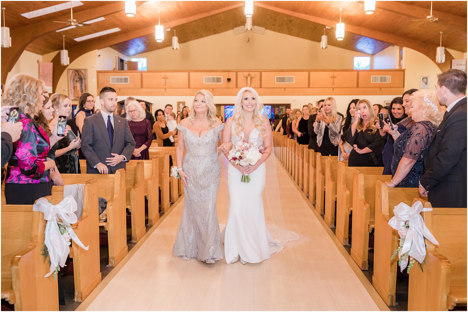 bride and mom walk down aisle for church wedding ceremony in Red Bank NJ