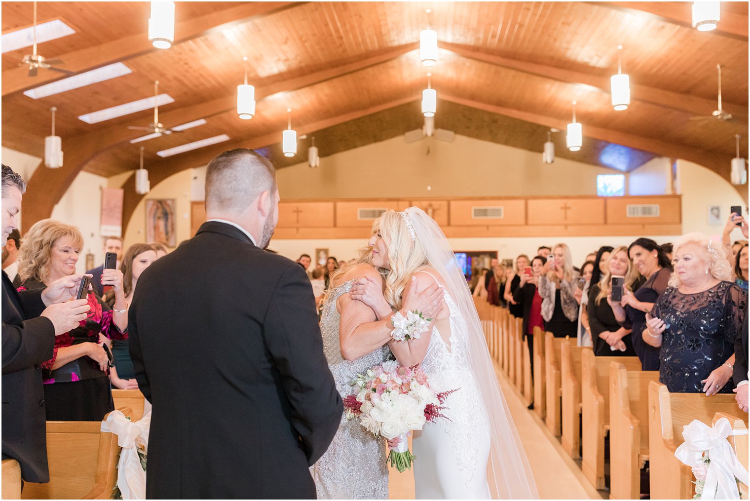 mom hugs bride during church wedding ceremony in Red Bank NJ