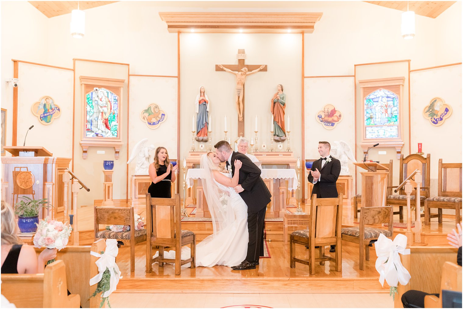 bride and groom kiss during church wedding ceremony in Red Bank NJ