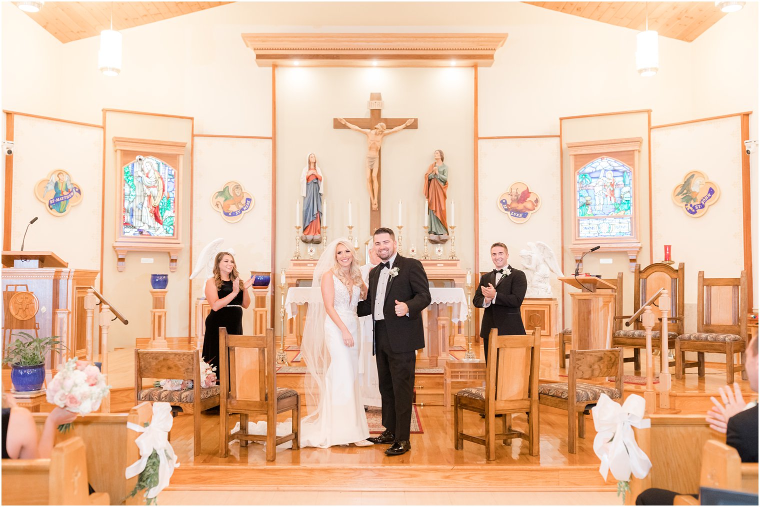 newlyweds smile to guests after church wedding ceremony in Red Bank NJ