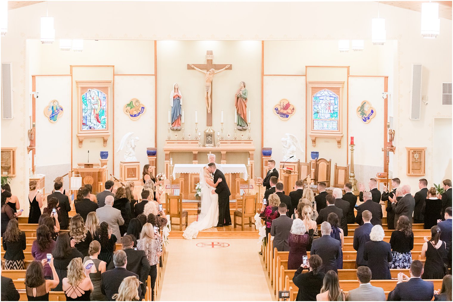 bride and groom's first kiss during church wedding ceremony in Red Bank NJ