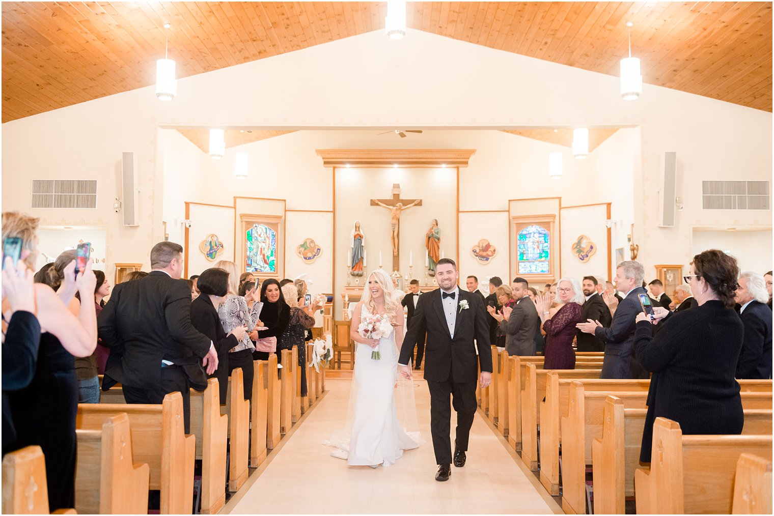 newlyweds recess up aisle after church wedding ceremony in New Jersey