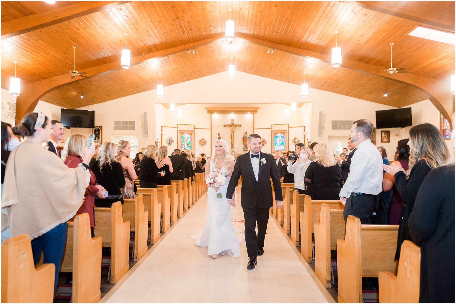 bride and groom walk up aisle after church wedding ceremony in New Jersey