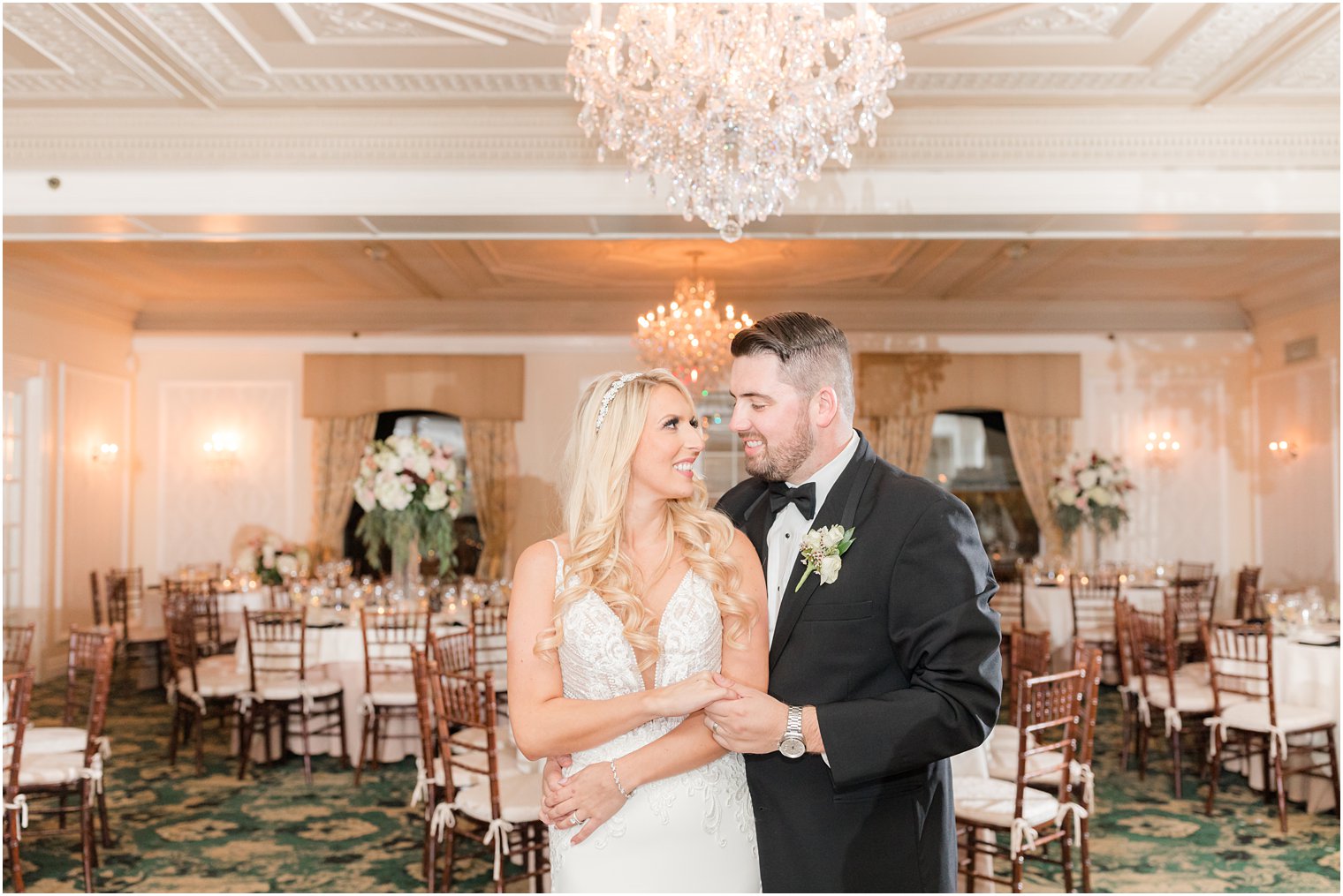 bride and groom hug in reception room at Molly Pitcher Inn