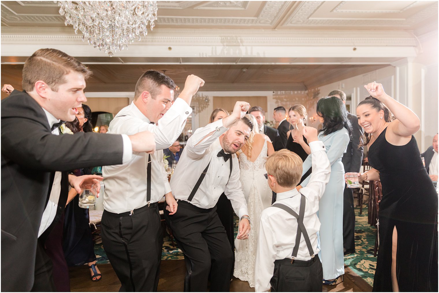 ring bearer dances with groomsmen during Red Bank NJ wedding reception