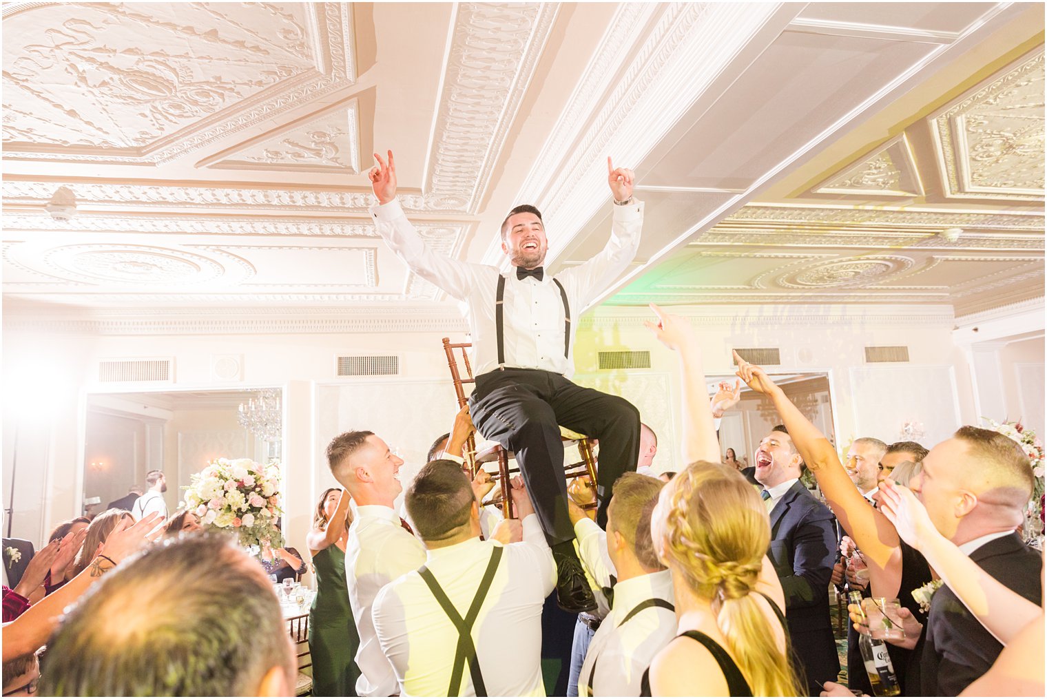 groomsmen lift groom in chair during Red Bank NJ wedding reception dancing 