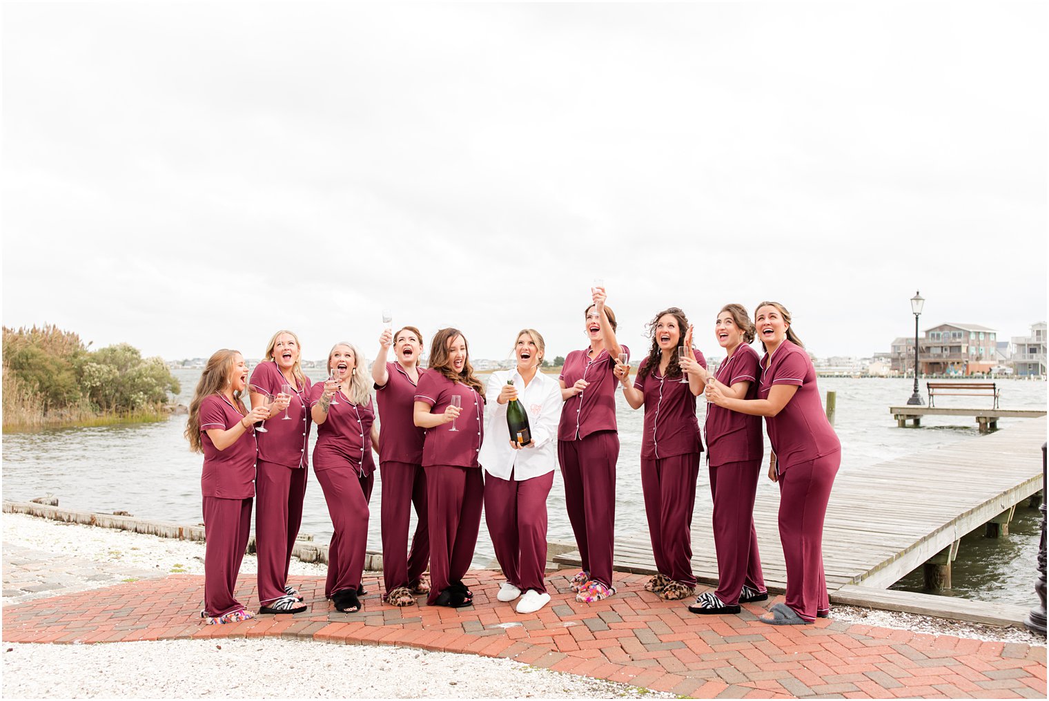 bride and bridesmaids pop champagne outside Bonnet Island Estate