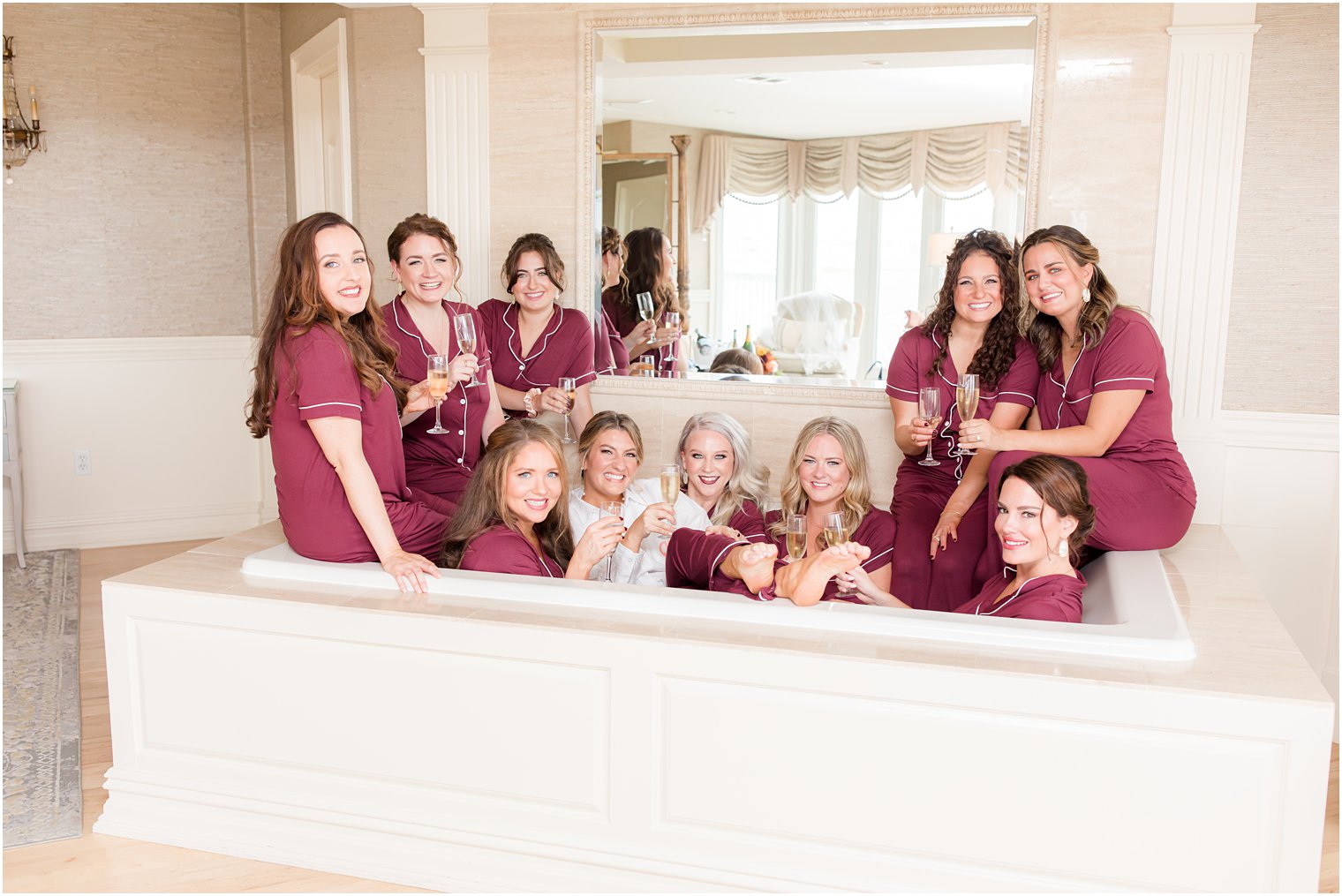 bride and bridesmaids pose in tub in matching pajamas at Bonnet Island Estate