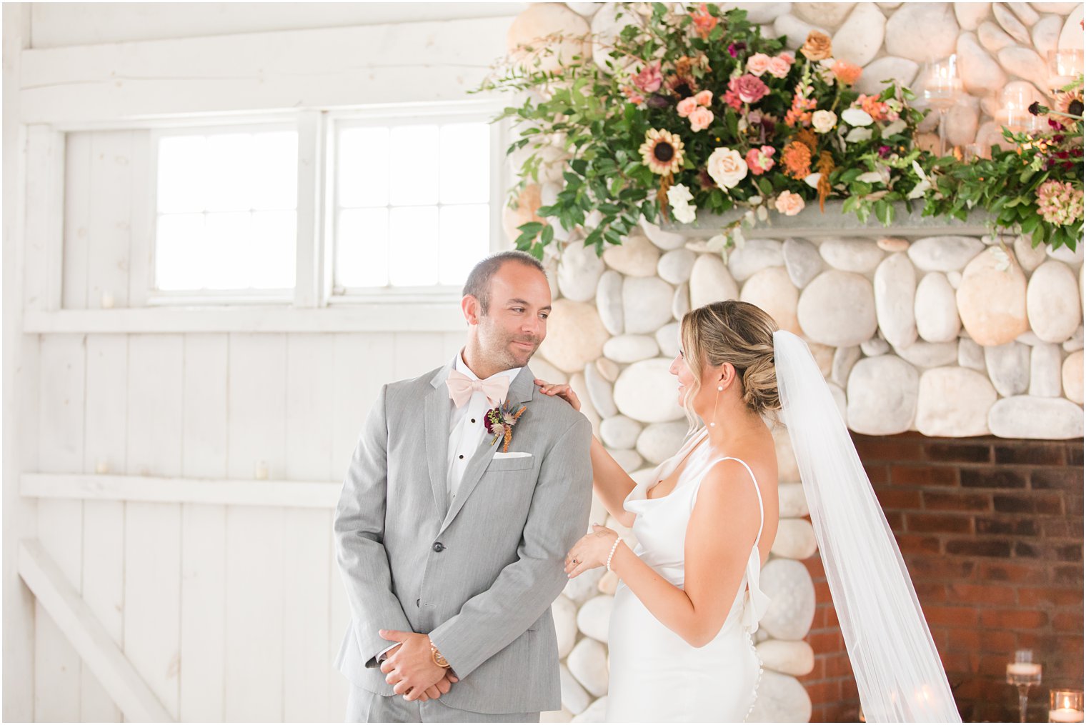 bride and groom have first look by fireplace at Bonnet Island Estate