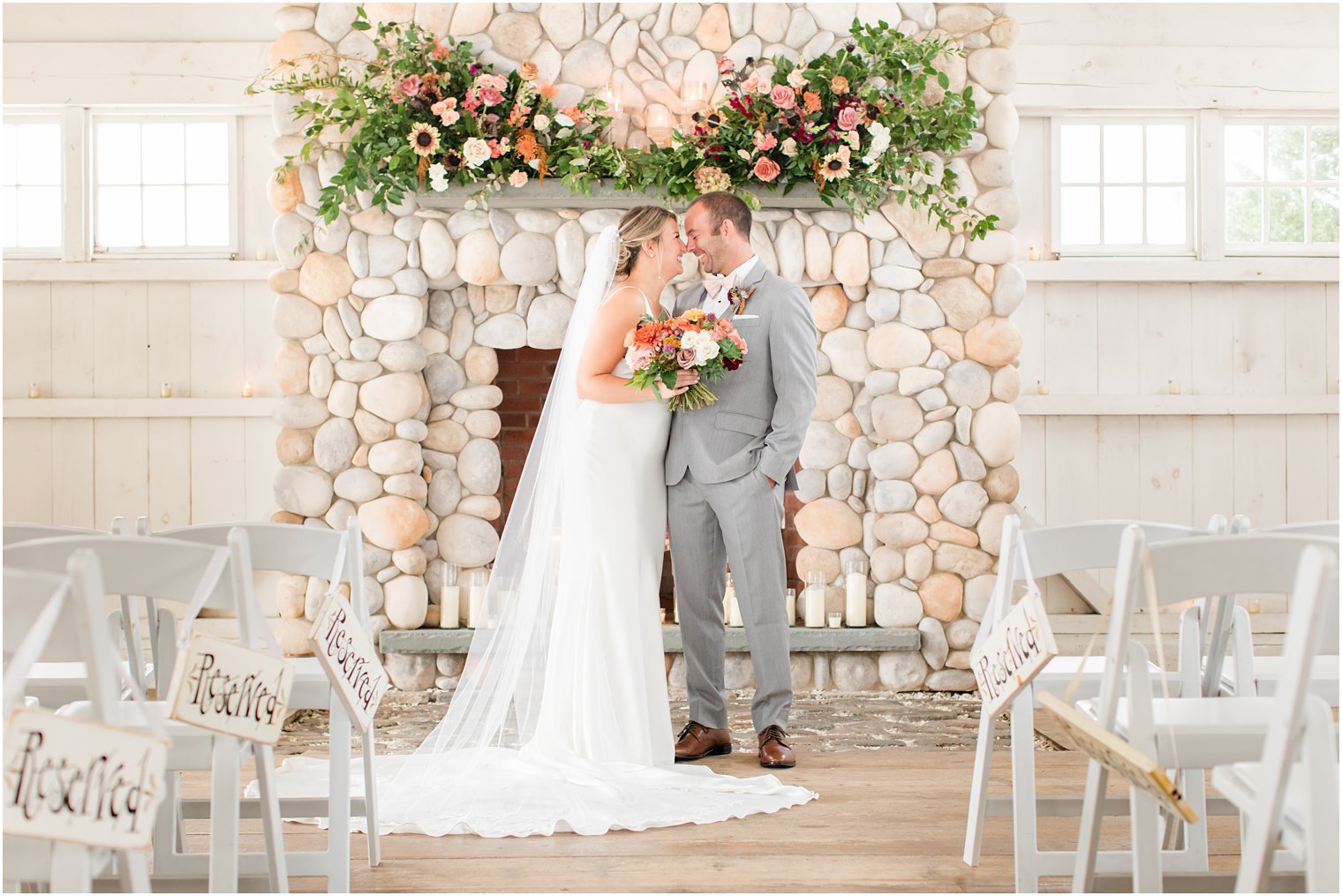 bride and groom laugh together by fireplace at Bonnet Island Estate