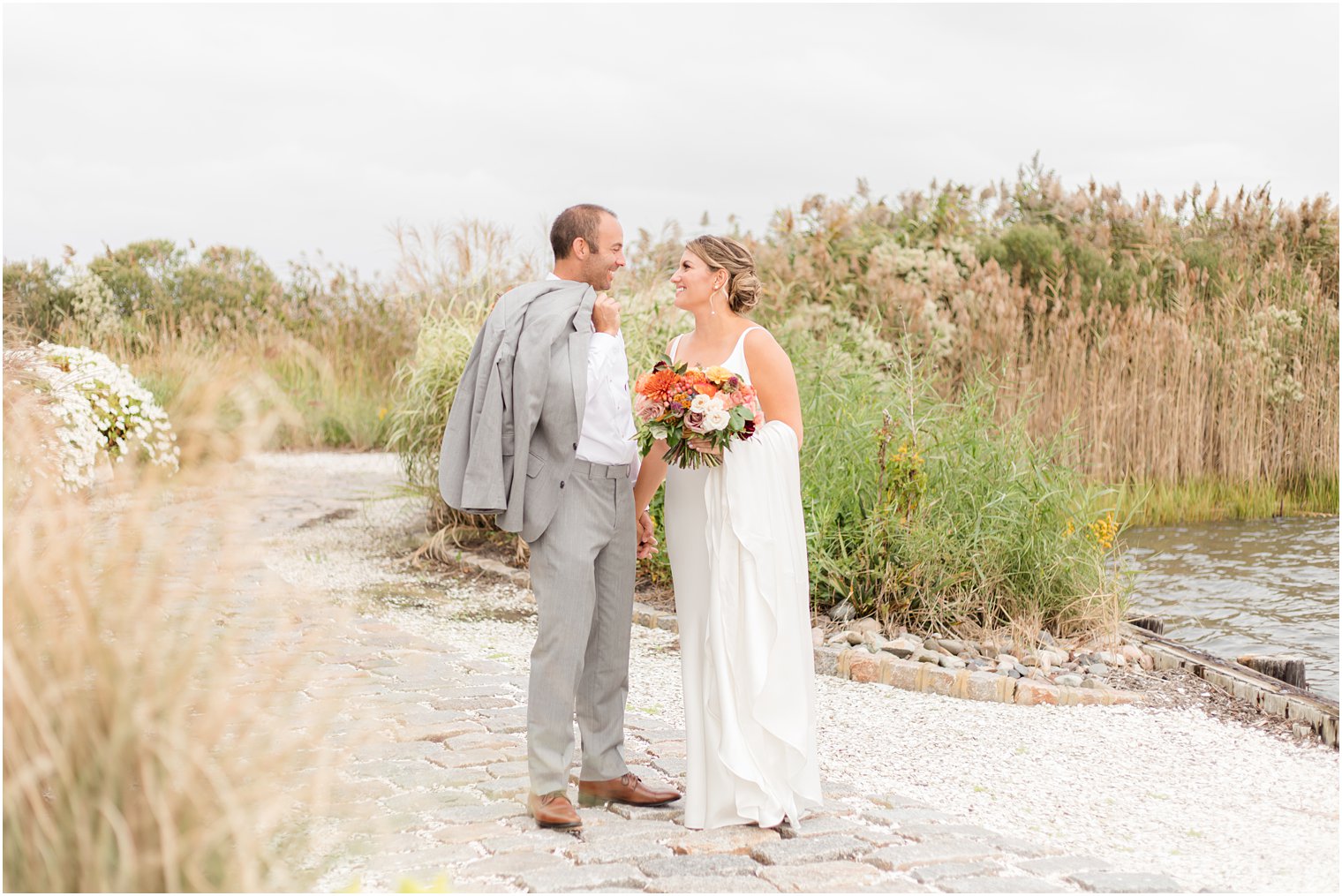 newlyweds talk on the beach during NJ wedding photos
