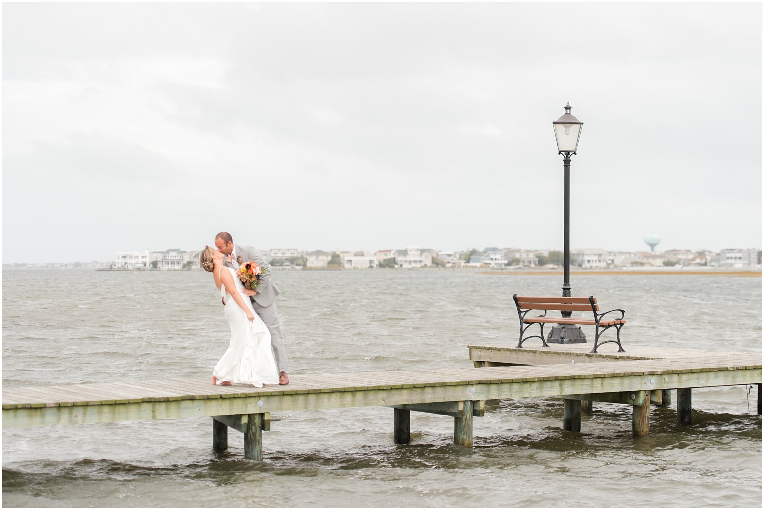 bride and groom kiss on dock at Bonnet Island Estate